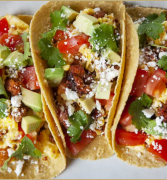 Chorizo and Egg Breakfast Tacos garnished with cilantro and queso fresco.