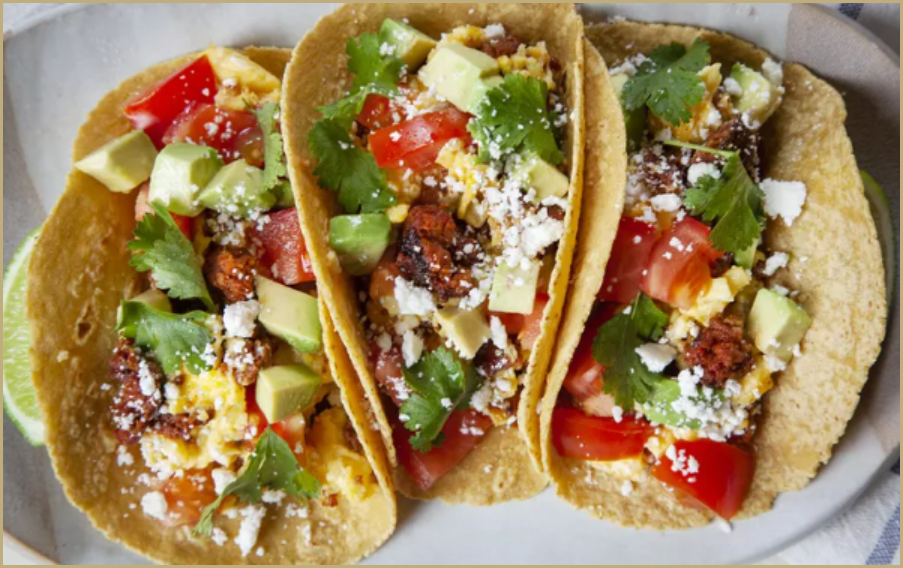 Chorizo and Egg Breakfast Tacos garnished with cilantro and queso fresco.